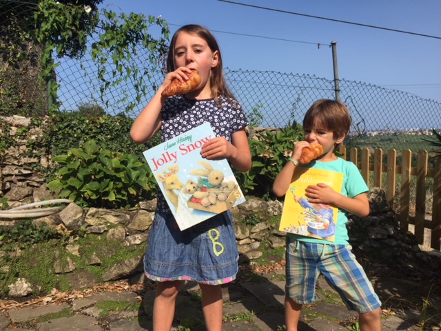 Alba and Rafa with the two competing manuscripts — The Dog that Mooed and the Cow that Woofd, and The Hole in Casey's Garden.